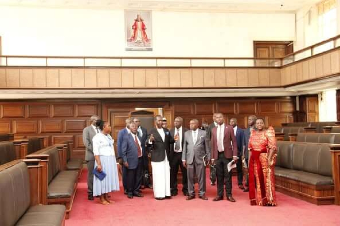 Guests from the Rwenzururu Kingdom are guided by Hon. Mugumbule through the Buganda Lukiiko Hall Guests from the Rwenzururu Kingdom are guided by Hon. Mugumbule through the Buganda Lukiiko Hall